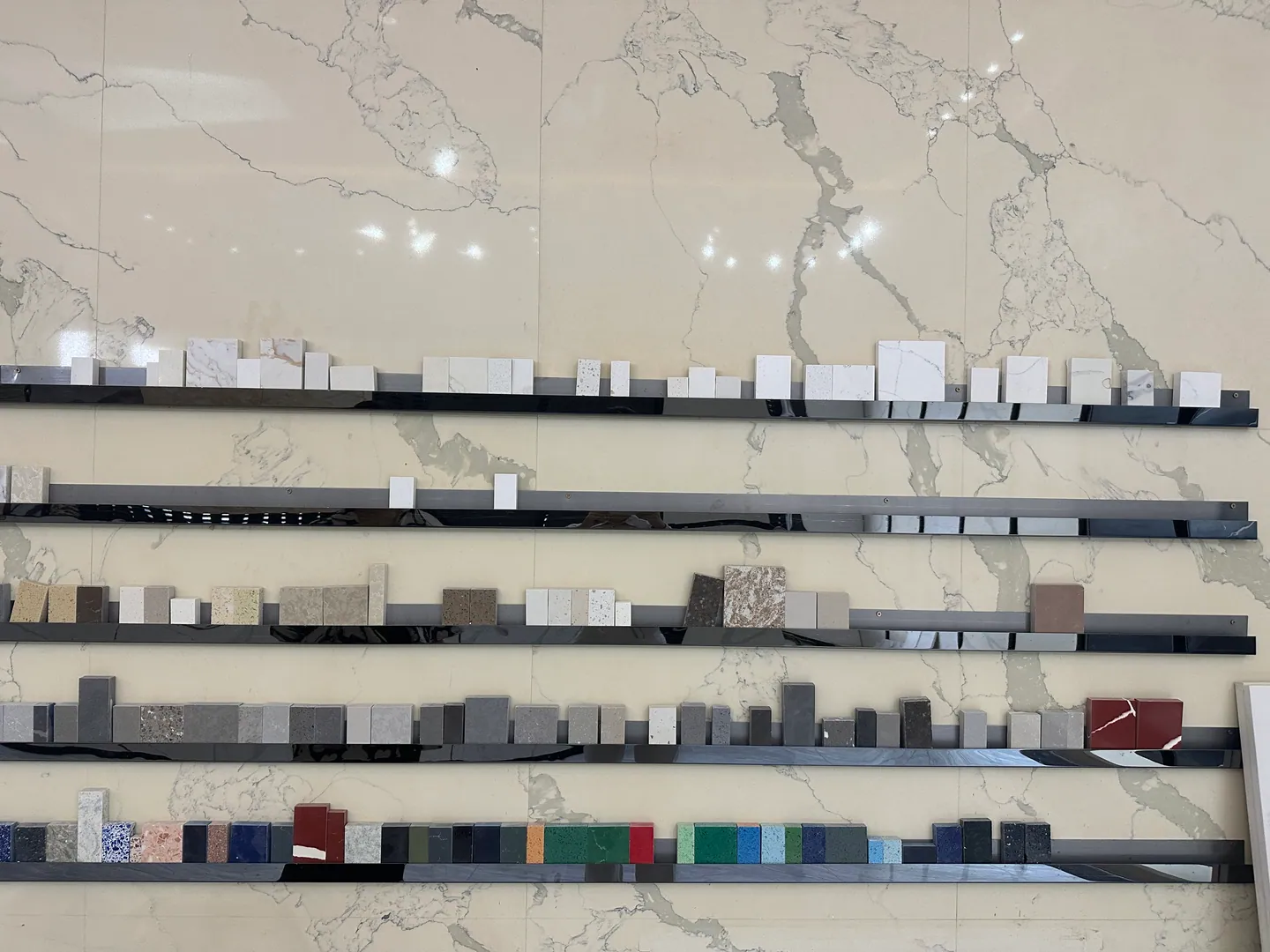 Stone and engineered-surface samples compared by VELA Home Global during Foshan building-material sourcing